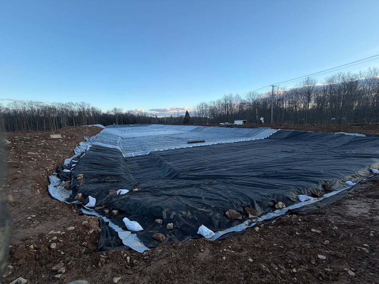 Geomembrane liner anchored with sandbags